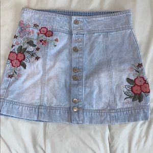 Light colored jean skirt with floral embroidery